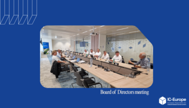 Board of Directors meeting in a modern conference room; attendees surround a long table with laptops and microphones; IC-Europe logo bottom right.