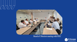 Group of directors around a long conference table in a meeting room, laptops and papers visible, discussing at a formal board meeting (FIEC)